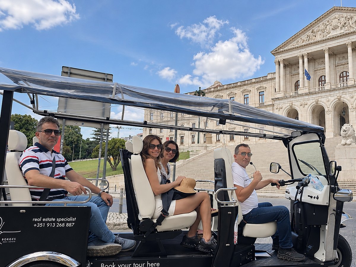 Guests riding a tuk tuk past the Portuguese parliament in Lisbon