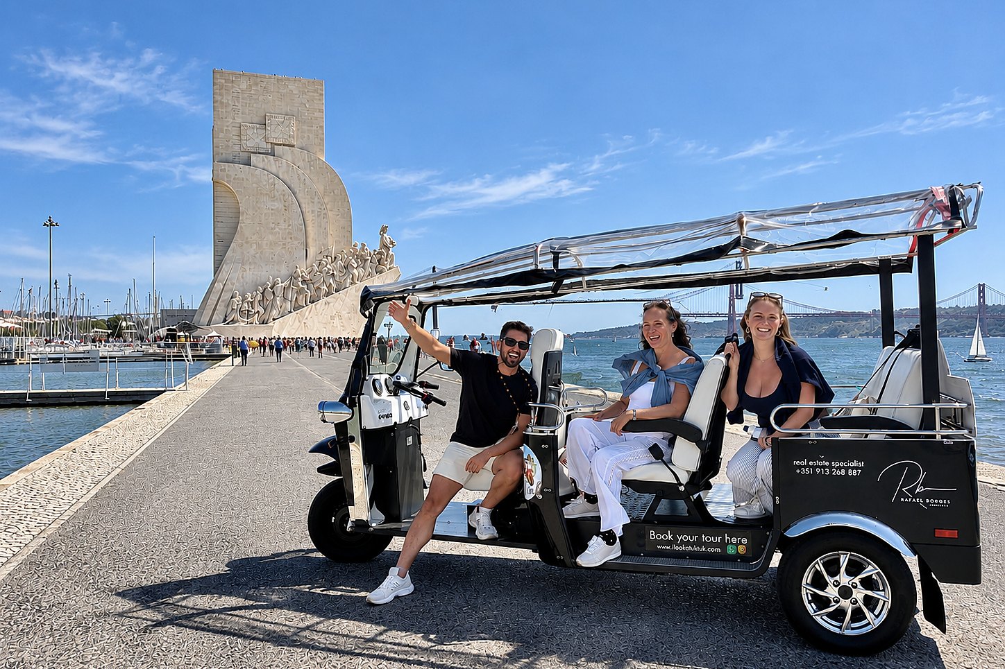 Guests in a private electric tuk tuk beside the Monument to the Discoveries in Bel&eacute;m