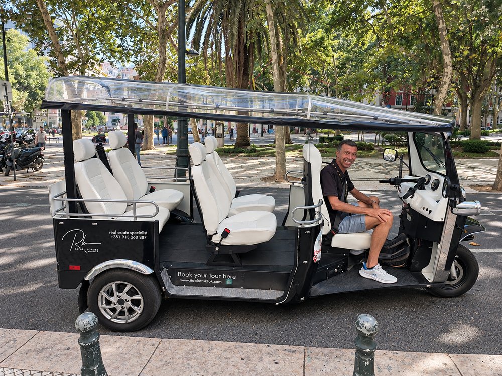 Side view of an electric tuk tuk fitted with wide individual captain’s seats